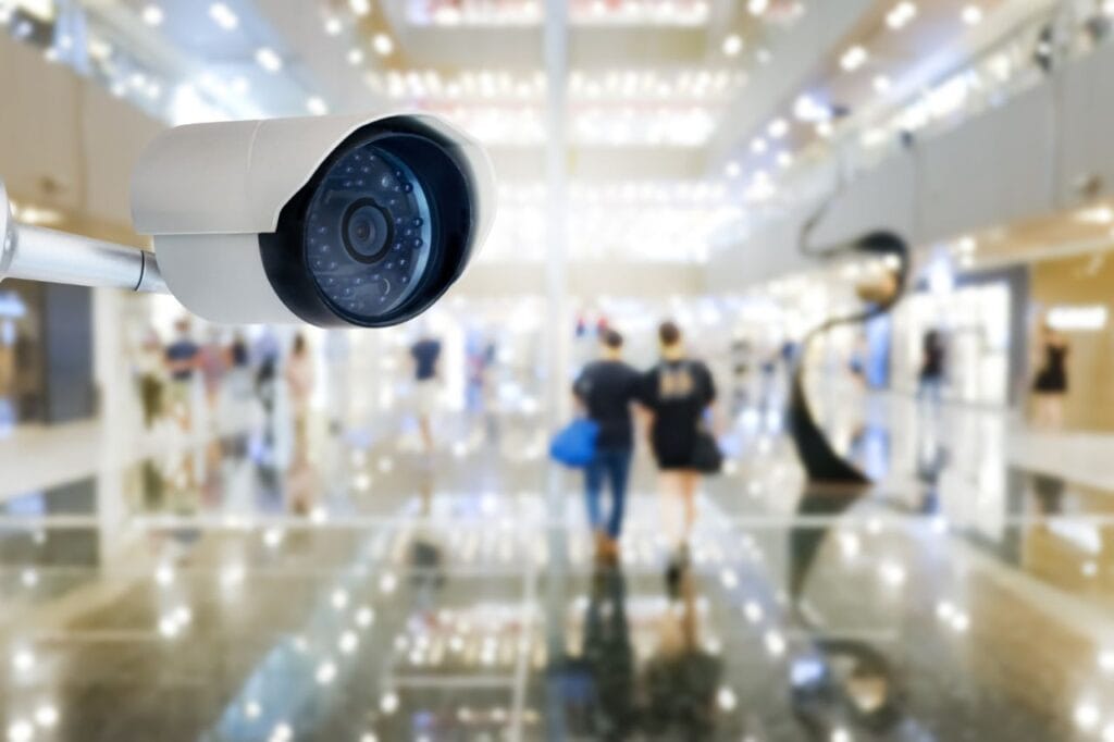 modern public cctv camera with blur interior shopping mall background copy space