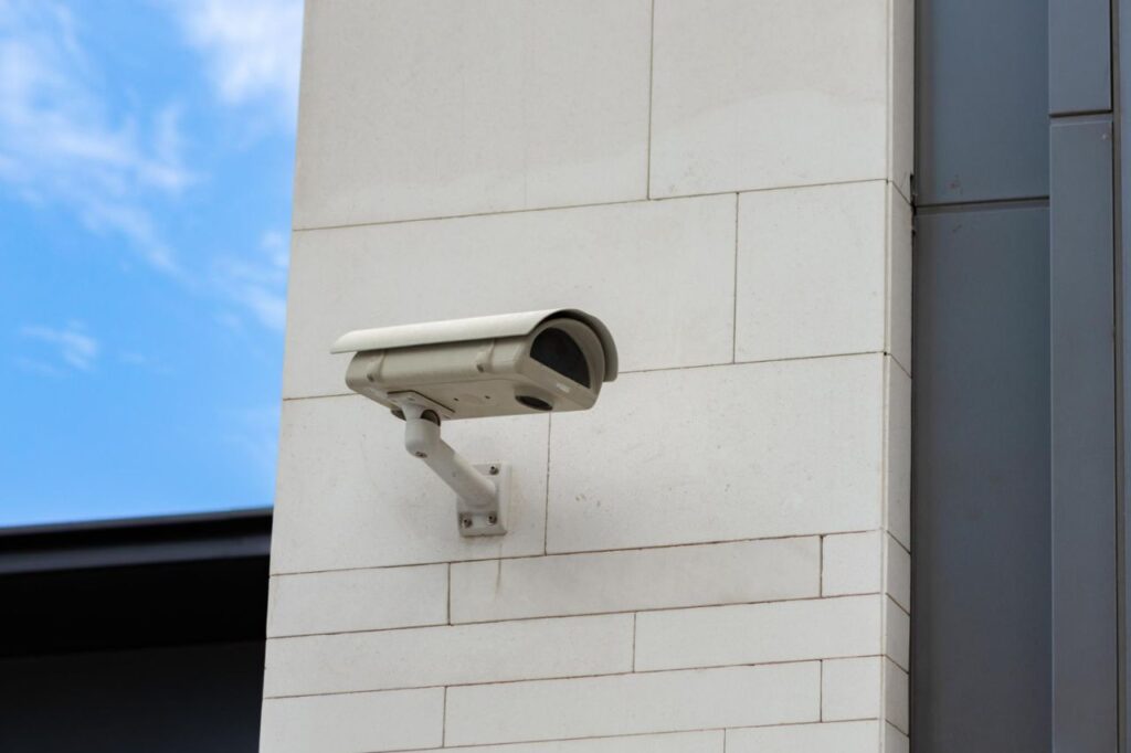 surveillance camera built into stone wall building